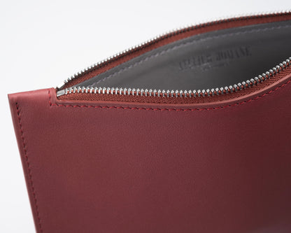 City clutch bag in burgundy leather